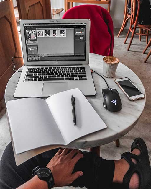 Notebook and Computer with pen, phone, and coffee